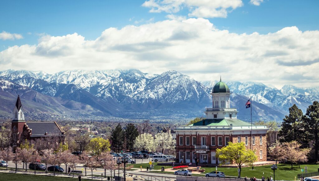 A picturesque view of Salt Lake City's historic buildings against the snow-capped mountains.